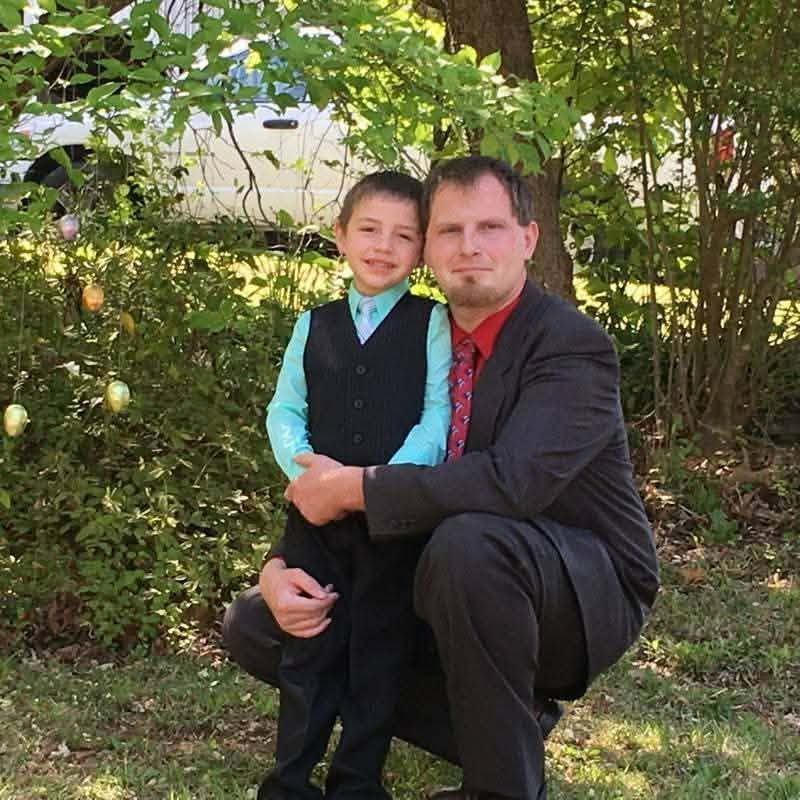 Joshua with his son, dressed up together outdoors