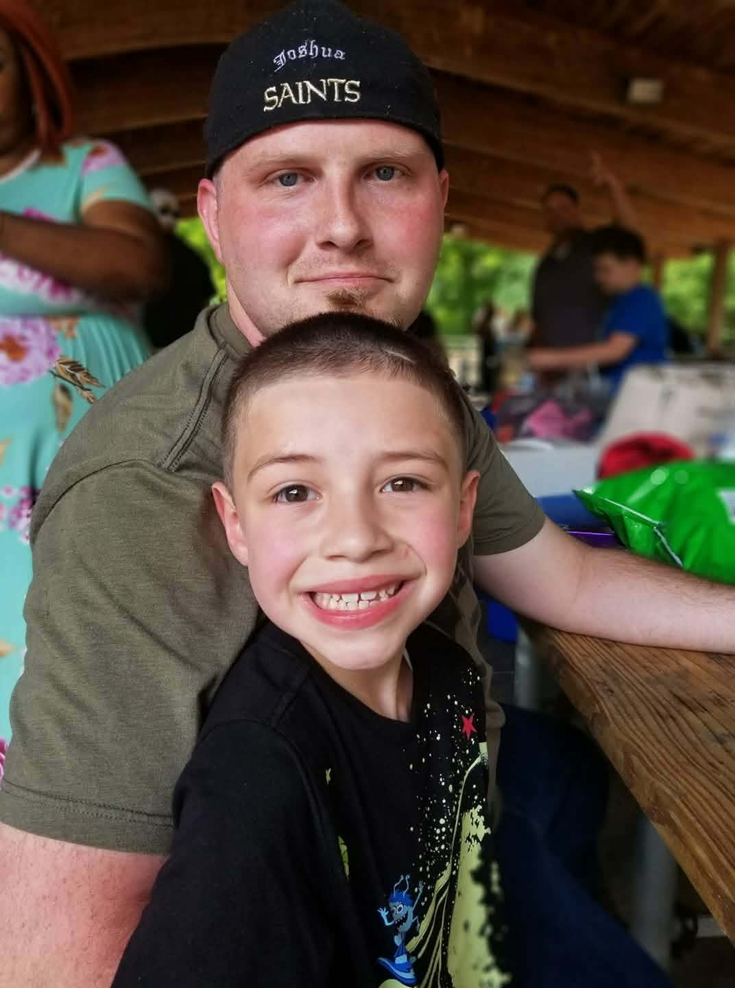 Joshua smiling with his son